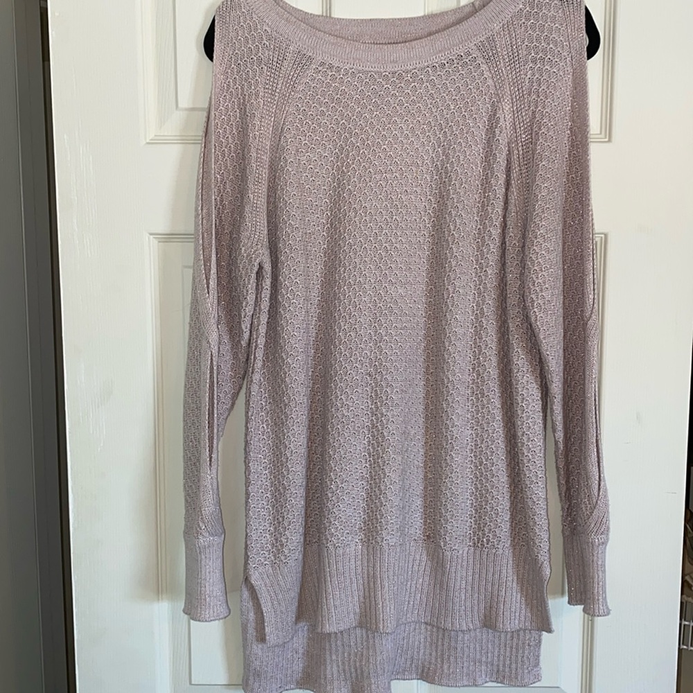 Long pink sweater with holes along the shoulder and arms